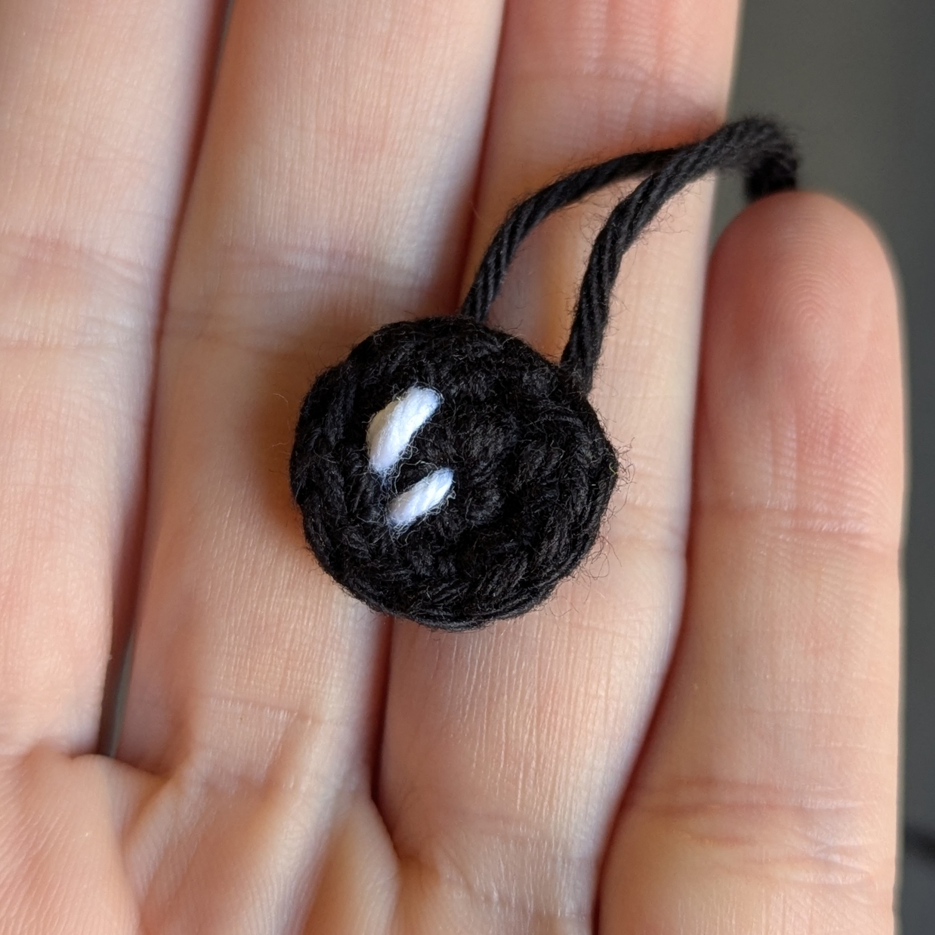 Crochet Grogu eye detail with yarn highlight